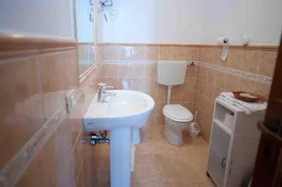a bathroom with a sink and a toilet at Residence Il Capo in Palermo