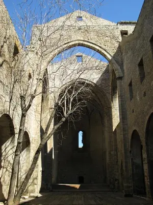 a large stone building with an archway at Casa Magione in Palermo