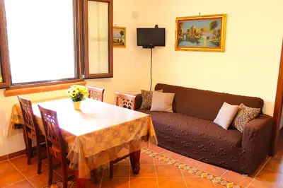 a living room with a table and a couch at Casale Orioles in Torretta