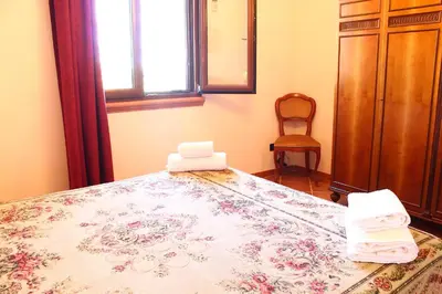 a bedroom with a bed with towels on it at Casale Orioles in Torretta