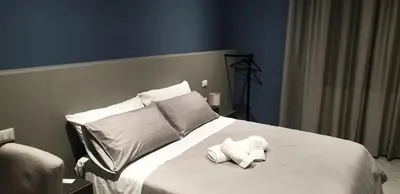 a bedroom with a white bed with two towels on it at Granatelli Rooms in Palermo