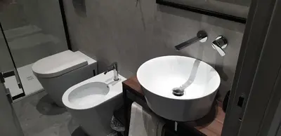 a bathroom with a white toilet and a sink at Granatelli Rooms in Palermo