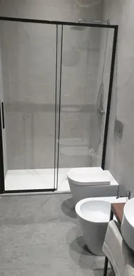 a bathroom with a shower and a toilet and a sink at Granatelli Rooms in Palermo