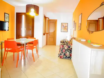 a kitchen and dining room with a table and chairs at CASE COLOMBO E MATTARELLA by Trerose Properties - Appartamenti centrali con wi-fi e posto auto privato gratuito in San Vito lo Capo