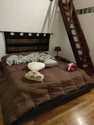 a large bed with pillows on it in a room at CASA MIKY in Palermo