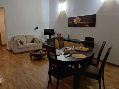 a living room with a table with chairs and a couch at CASA MIKY in Palermo