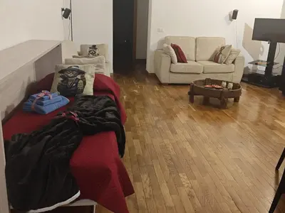 a living room with a bed and a couch at CASA MIKY in Palermo