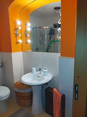 a bathroom with a sink and a toilet and a mirror at CASA MIKY in Palermo