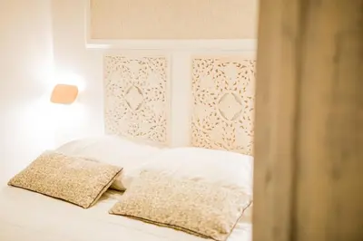 a white bed with two pillows on top of it at Casale D' Or in Palermo