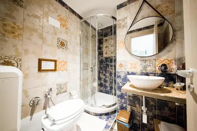 a bathroom with a toilet and a sink and a mirror at Casale D' Or in Palermo
