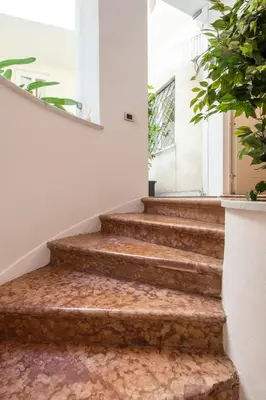 a set of stairs in a room with plants at Moncada Suites & Apartments in Palermo