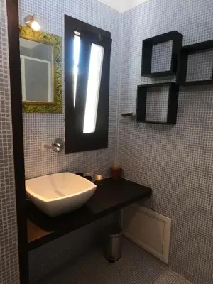 a bathroom with a sink and a mirror at casa magoo in Palermo