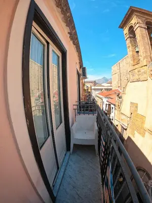 a balcony with a window and a bench on a building at casa magoo in Palermo