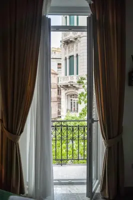 an open glass door with a view of a building at Ai Giudici in Palermo