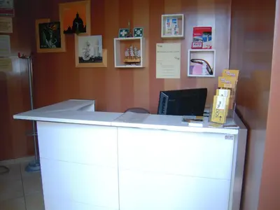 a white counter with a computer on top of it at Case Vacanze Anni 20 in Bagheria