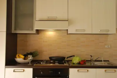 a kitchen counter with a stove and a sink at Case Vacanze Anni 20 in Bagheria