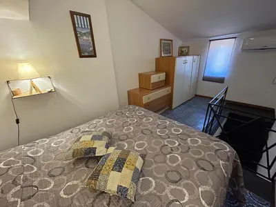 a bedroom with a bed and a dresser and a window at Suite Dreams Politeama in Palermo