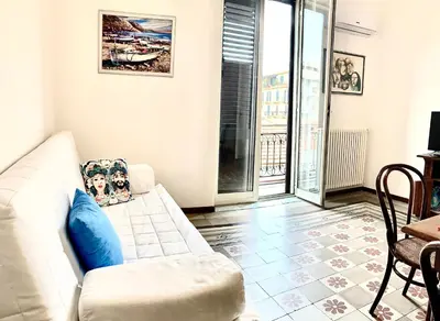 a living room with a white couch and a table at Suite Dreams Politeama in Palermo