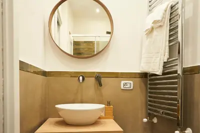 a bathroom with a sink and a mirror at Ballarò Guest House in Palermo