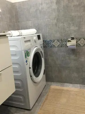 a washer and dryer in a bathroom at La Casetta Paternò “Nel Cuore Pulsante di Palermo” in Palermo