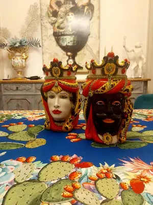 two masks are sitting on a table at LE VELE in Palermo