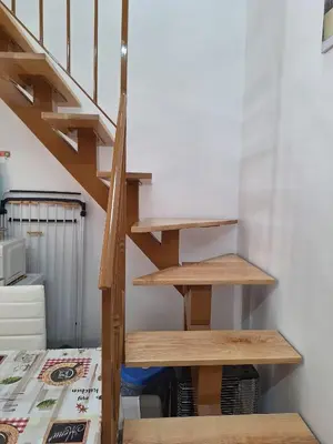 a stairwell with wooden shelves next to a bed at Casa dolce casa in Partinico