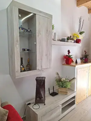 a living room with a wooden cabinet and a table at Casa dolce casa in Partinico