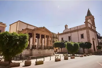 an old building with trees in front of it at Casa dolce casa in Partinico