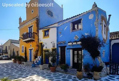 a blue and yellow building with potted plants on a street at Casa dolce casa in Partinico
