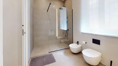 a bathroom with a toilet and a shower at Parlamento Apartment - Esclusivo 120mq centro storico Palermo in Palermo