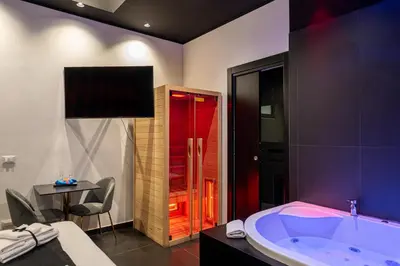 a bathroom with a tub and a table and a chair at Maximum hub suite&spa in Palermo