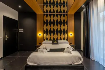 a bedroom with a large bed with towels on it at Maximum hub suite&spa in Palermo