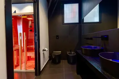 a bathroom with two sinks and a mirror at Maximum hub suite&spa in Palermo