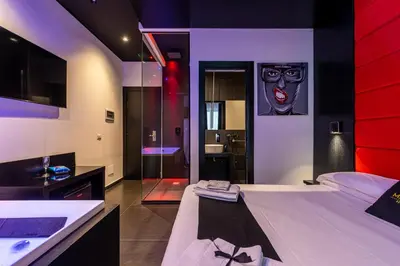 a bedroom with two beds and a bathroom at Maximum hub suite&spa in Palermo
