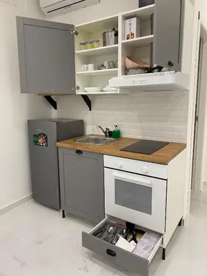 a small kitchen with a sink and a refrigerator at Vittorio Emanuele & Quattro Canti Suite Palermo in Palermo