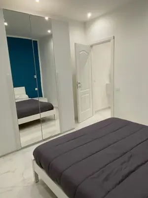 a bedroom with a large bed and a mirror at Vittorio Emanuele & Quattro Canti Suite Palermo in Palermo
