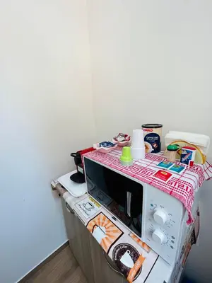 a microwave sitting on top of a counter at SicilyHouse Palermo in Palermo