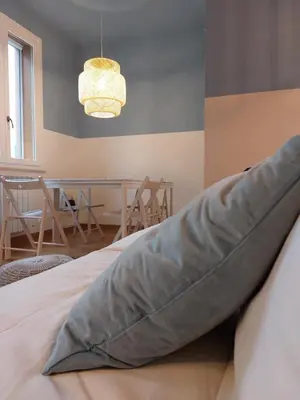 a large pillow sitting on top of a bed at Piazza Mondello Lifestyle Home Palermo in Mondello