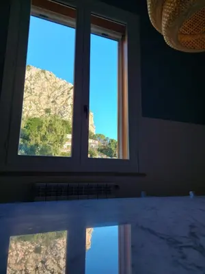 a window in a room with a reflection in the water at Piazza Mondello Lifestyle Home Palermo in Mondello