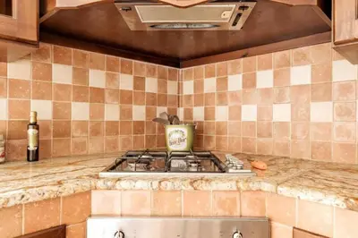 a kitchen with a stove and a counter top at Tavola tonda apartament in Palermo