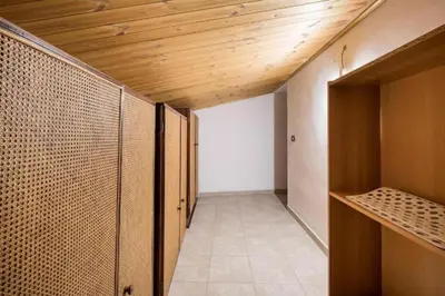 a room with wooden ceilings and a hallway with closets at Tavola tonda apartament in Palermo