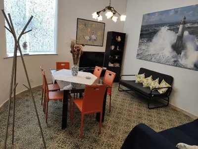 a dining room with a table and chairs at Seafront Apartment in Villa with Swimming Pool and Parking in Alcamo Marina