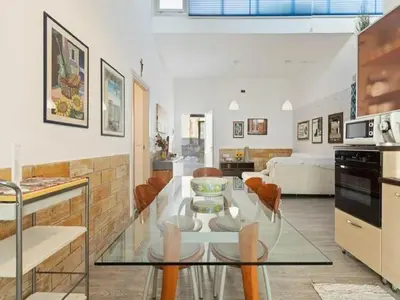 a kitchen and living room with a glass table at Seafront Apartment in Villa with Swimming Pool and Parking in Alcamo Marina
