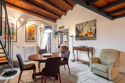 a living room with a table and chairs at Panormus Cala a Mare by DomuSicily in Palermo