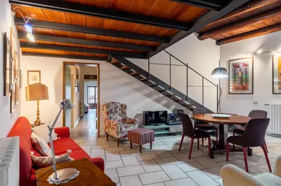 a living room with a red couch and a table at Panormus Cala a Mare by DomuSicily in Palermo