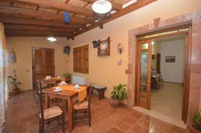 a dining room with a table and chairs in a room at Cascina degli Ulivi in Castelluzzo