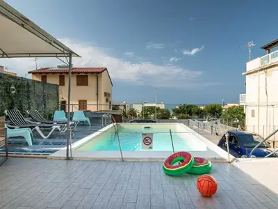 a swimming pool with two balls and a volley ball at Alcamo Marina Villa Pool in Alcamo Marina