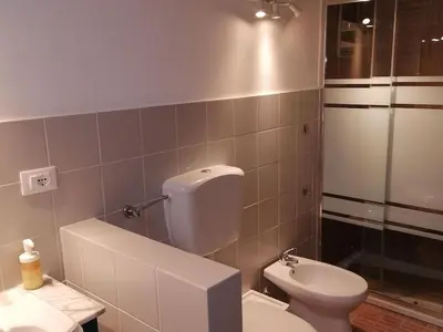 a bathroom with a white toilet and a sink at Alcamo Marina Villa Pool in Alcamo Marina