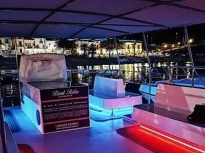 a boat with blue and purple lights on it at Alcamo Marina Villa Pool in Alcamo Marina