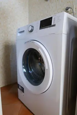 a white washing machine sitting in a room at N'Amuri di Casa in Palermo